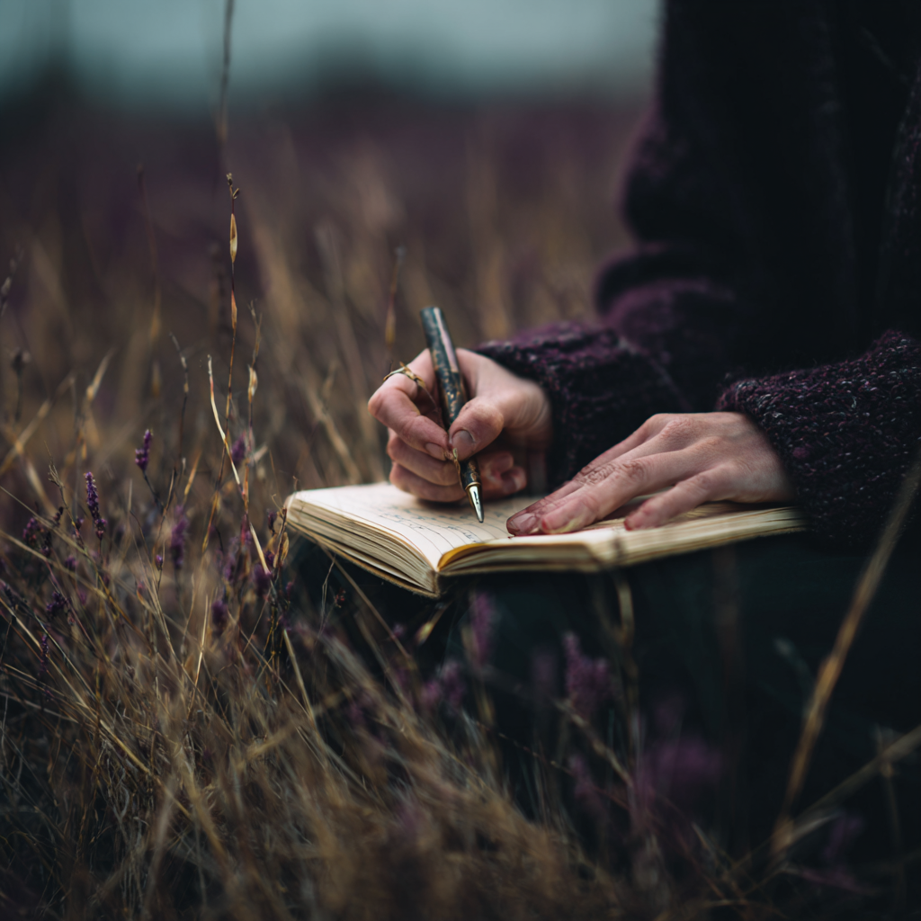 A woman writing in her journal — capturing observations from the field
